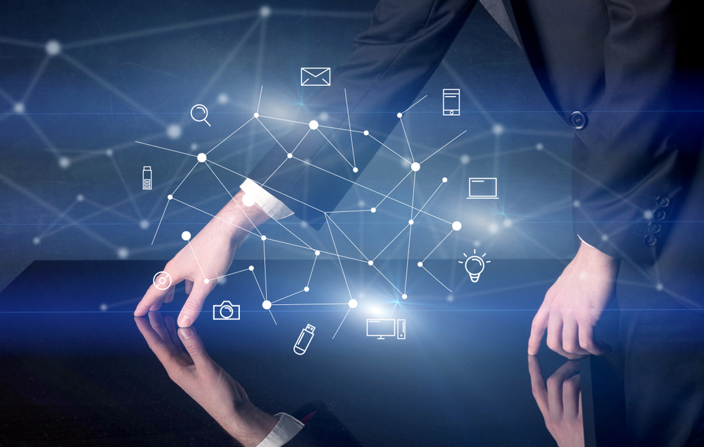 Male hands touching interactive table with blue mixed communication icons in the background